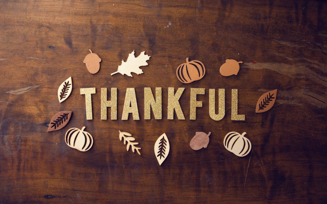 Thankful written with punch out letters on a wood table