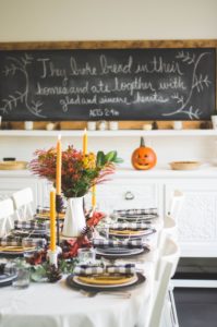 Table set for Thanksgiving with chalkboard text in the background